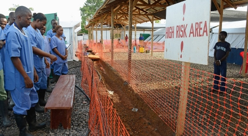 Photo: IRIN/Ricci Shryock Health workers start the day praying with Ebola patients in a treatment centre, Kenema, Sierra Leone