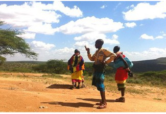 Kenyan pastoralist use the GrazeIt app to take a picture of the vegetation and submit a survey. Credit: Nathaniel Jensen, Cornell University